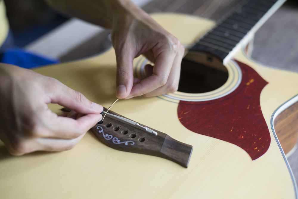 Restringing services East Toronto - restringing an acoustic guitar